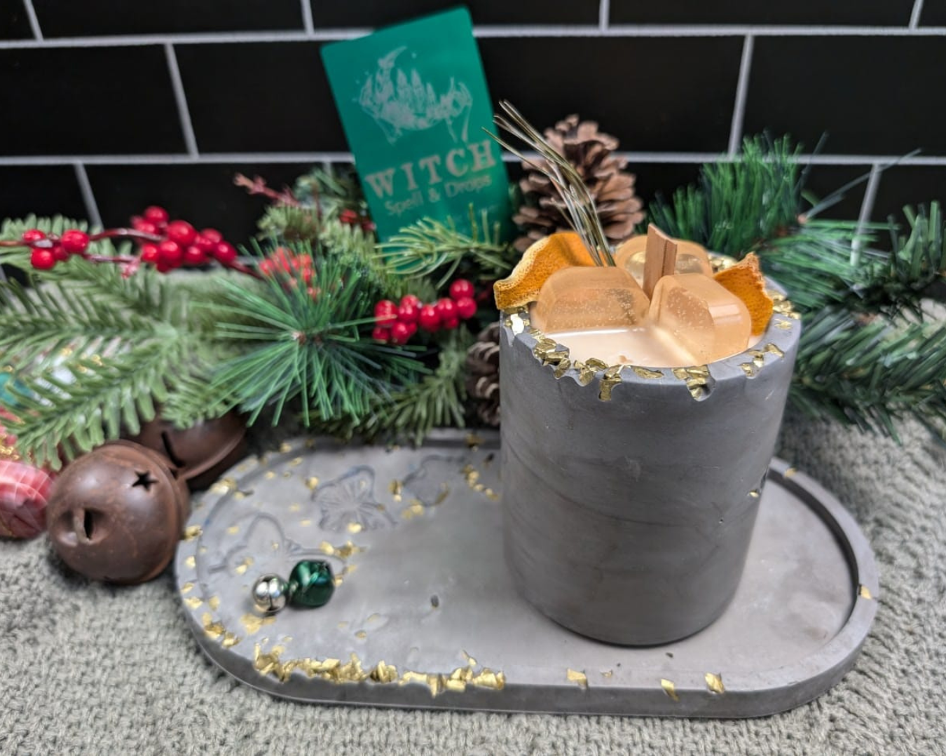 A candle With Ice cube wax, simulating a drink on concrete jar. On top of a concrete plate