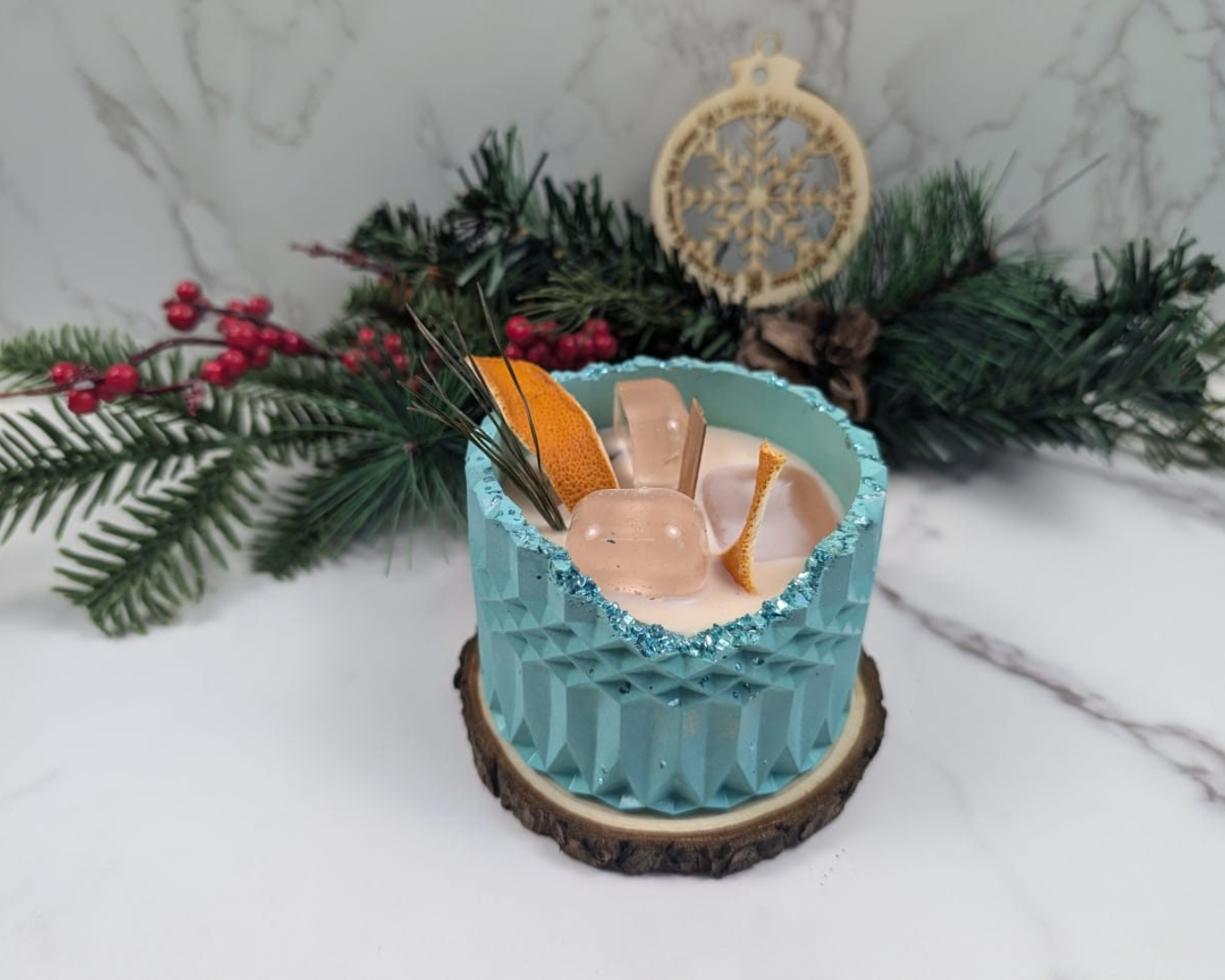 A candle With Ice cube wax, simulating a drink on concrete jar. 