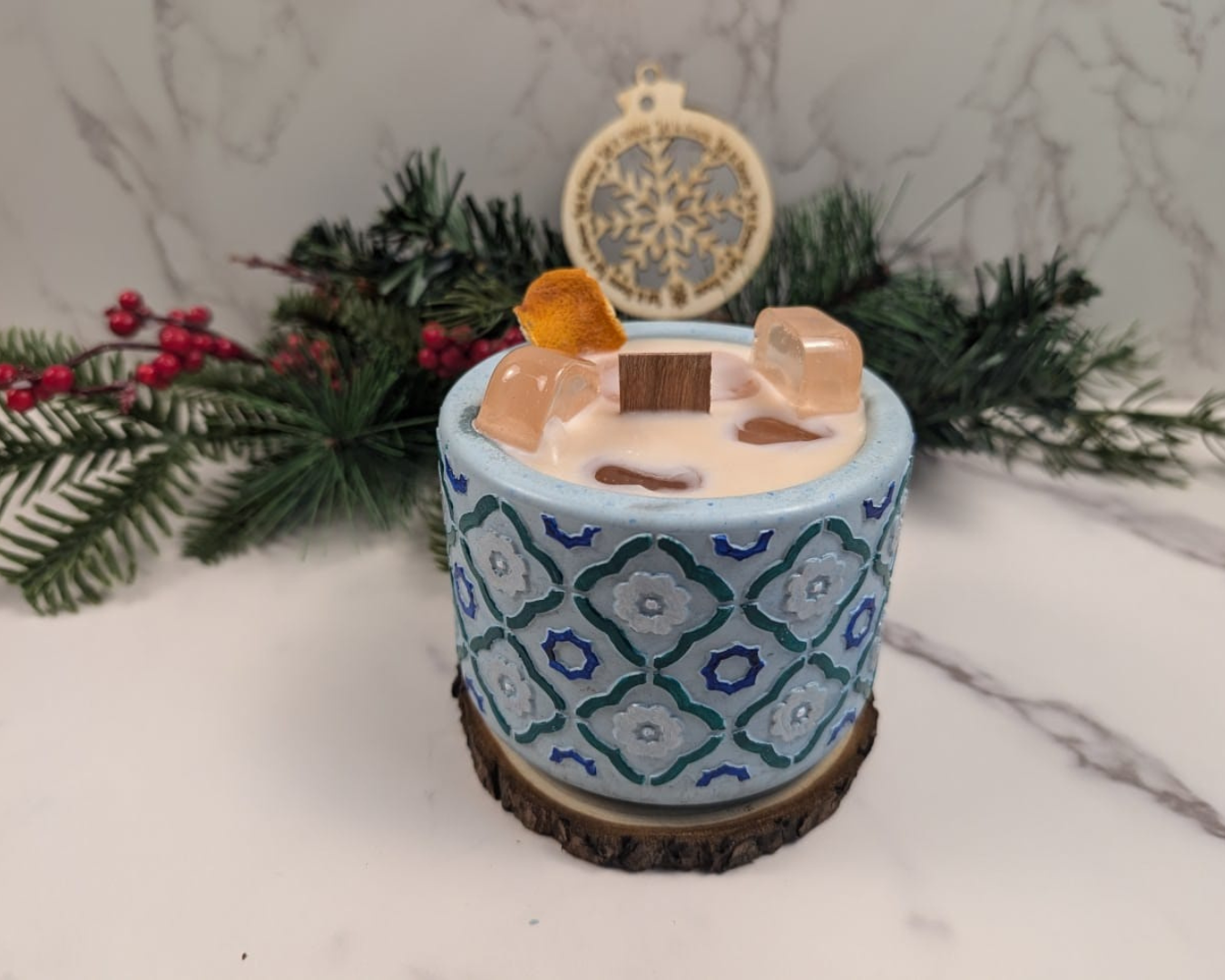 A candle With Ice cube wax, simulating a drink on concrete jar. 