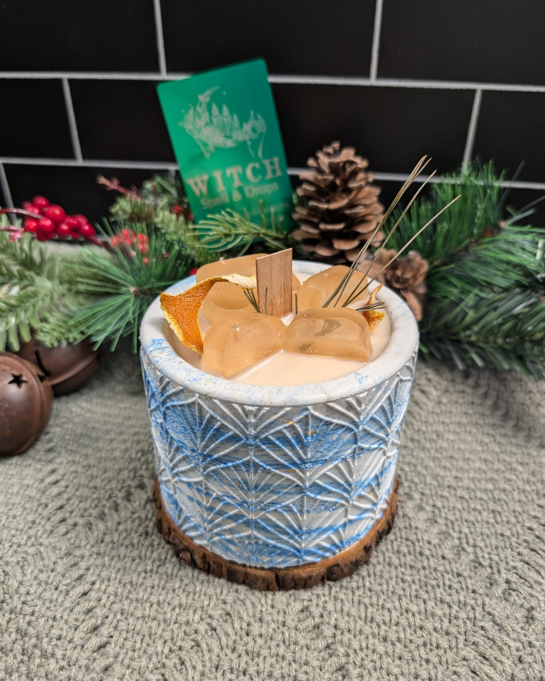 A candle With Ice cube wax, simulating a drink on concrete jar. 